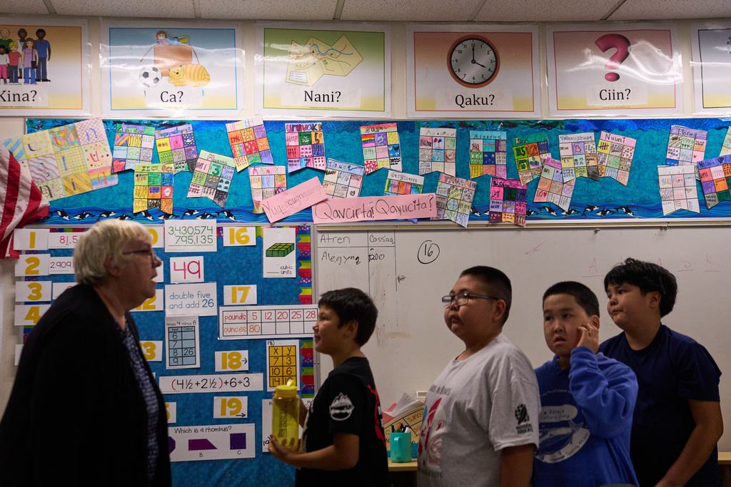 Signs in the Yup'ik language are seen on the walls as students line up to leave a classroom at College Gate Elementary, where students spend half their time learning in Yup'ik language immersion, Thursday, Oct. 30, 2025, in Anchorage, Alaska. (AP Photo/Lindsey Wasson)