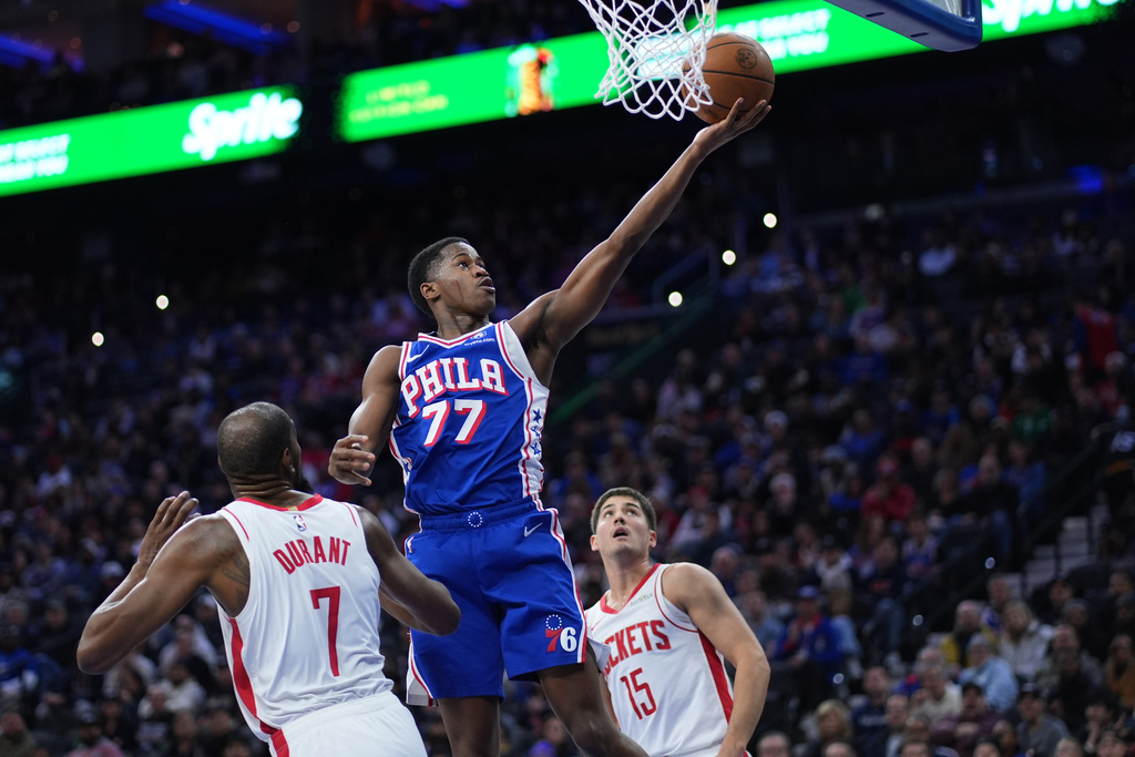 Philadelphia 76ers' VJ Edgecombe (77) goes up for a shot against Houston Rockets' Kevin Durant (7) and Reed Sheppard (15) during the first half of an NBA basketball game Thursday, Jan. 22, 2026, in Philadelphia. (AP Photo/Matt Slocum)