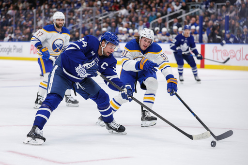 Toronto Maple Leafs' Auston Matthews battles for the puck with Buffalo Sabres' Josh Doan (91) during the second period of an NHL hockey game in Toronto, Saturday, Oct. 25, 2025. (Nick Iwanyshyn/The Canadian Press via AP) Toronto Maple Leafs' Auston Matthews battles for the puck with Buffalo Sabres' Josh Doan (91) during the second period of an NHL hockey game in Toronto, Saturday, Oct. 25, 2025. (Nick Iwanyshyn/The Canadian Press via AP)