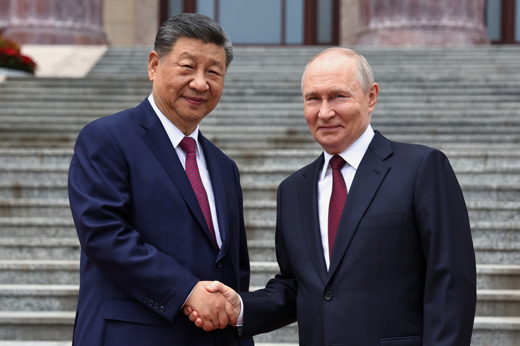 Russian President Vladimir Putin, right, and Chinese President Xi Jinping shake hands during a welcome ceremony at the Great Hall of the People, in Beijing, China, on Wednesday, May 20, 2026. (Alexander Kazakov, Sputnik, Kremlin Pool Photo via AP)