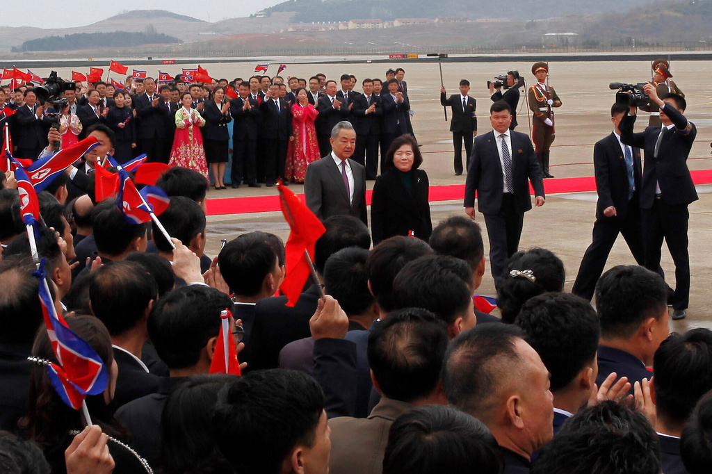 Chinese Foreign Minister Wang Yi, center left, walks with North Korean Foreign Minister Choe Son Hui, center right, on his arrival at the Pyongyang International Airport in Pyongyang, North Korea Thursday, April 9, 2026. (AP Photo/Jon Chol Jin)