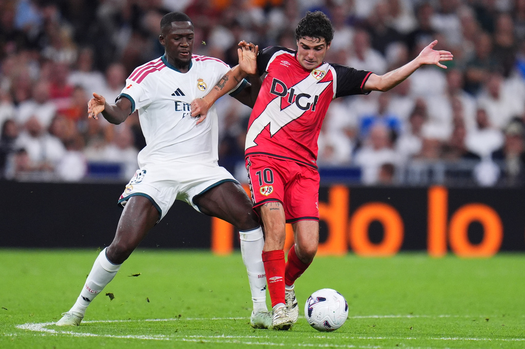 Real Madrid's Ibrahima Konate, left, challenges Rayo's Sergio Camello during the Spanish La Liga soccer match between Real Madrid and Rayo Vallecano in Madrid, Spain, Saturday, Sept. 12, 2026. (AP Photo/Manu Fernandez)