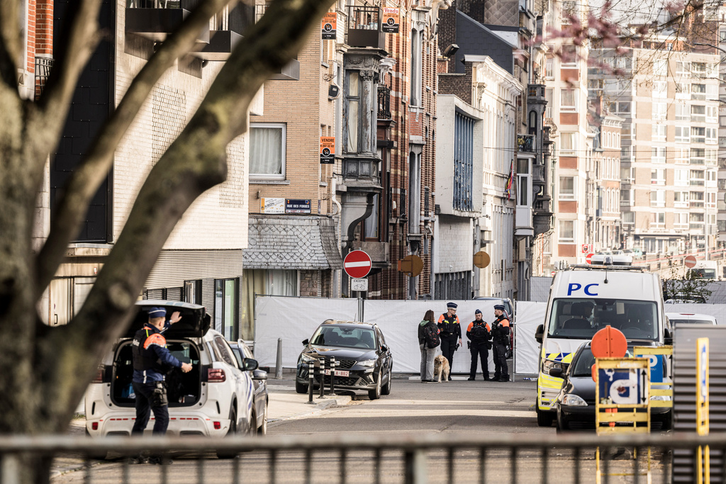 Police stand near barricades as they secure an area after a blast took place near a synagogue, in Liege, Belgium, Monday, March 9, 2026. (AP Photo/Valentin Bianchi)