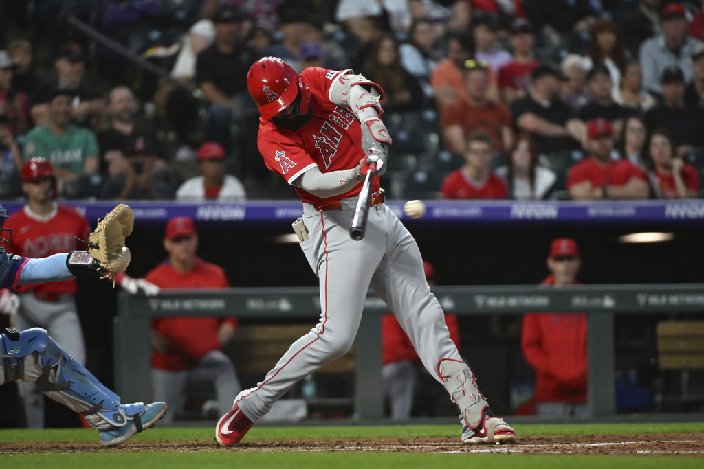 Los Angeles Angels' Jo Adell hits a single in the fourth inning of a baseball game against the Colorado Rockies Friday, Sept. 19, 2025, in Denver. (AP Photo/Geneva Heffernan)