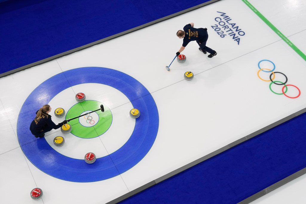 Sweden's Rasmus & Isabella Wranaa compete during a curling mixed doubles session against South Korea at the 2026 Winter Olympics in Cortina d'Ampezzo, Italy, Wednesday, Feb. 4, 2026. (AP Photo/David J. Phillip)