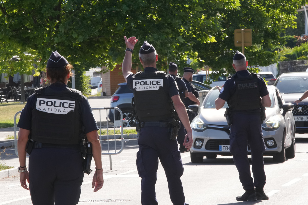 France Police officers control cars at a check point ahead of the G7 summit in Evian-les-Bains, France, Monday, June 15, 2026. (AP Photo/Christophe Ena)