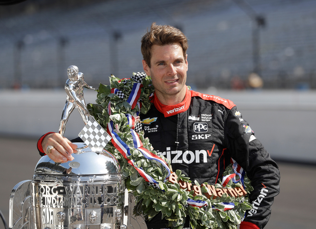 FILE Indianapolis 500 champion Will Power, of Australia, poses with the Borg-Warner Trophy during the traditional winners photo session on the start/finish line at the Indianapolis Motor Speedway, May 28, 2018, in Indianapolis. (AP Photo/Darron Cummings, File)