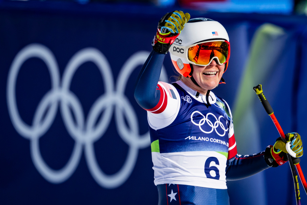 Breezy Johnson of the United States reacts in the finish area of the alpine ski women's downhill race, at the 2026 Winter Olympics, in Cortina d'Ampezzo, Italy, Sunday, Feb. 8, 2026. (Jean-Christophe Bott, Keystone via AP)