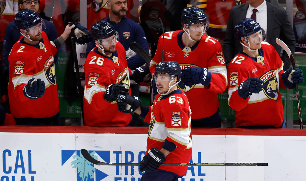 Florida Panthers left wing Brad Marchand (63) celebrates his goal with teammates in the second period of an NHL hockey game against the Tampa Bay Lightning, Saturday, Dec. 27, 2025, in Sunrise, Fla. (AP Photo/Rhona Wise)