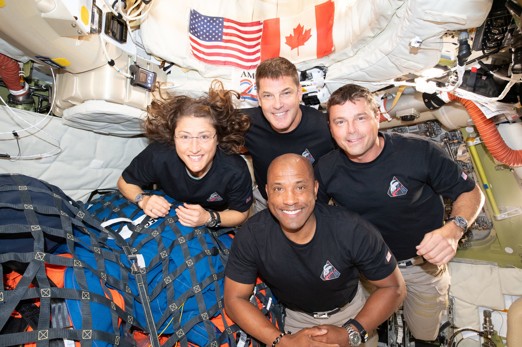 In this image provided by NASA, the Artemis II crew, clockwise from left, Mission Specialist Christina Koch, Mission Specialist Jeremy Hansen, Commander Reid Wiseman, and Pilot Victor Glover, pause for a group photo inside the Orion spacecraft on their way home on Wednesday, April 7, 2026. (NASA via AP)