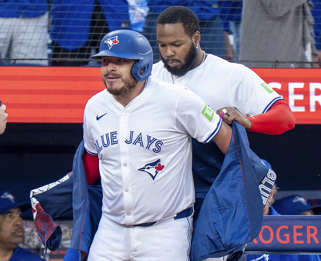 Toronto Blue Jays designated hitter Vladimir Guerrero Jr., right, puts the home run jacket on teammate Alejandro Kirk, left, after Kirk's two-run home run against the Minnesota Twins in first-inning baseball game action in Toronto, Monday, Aug. 25, 2025. (Frank Gunn/The Canadian Press via AP)