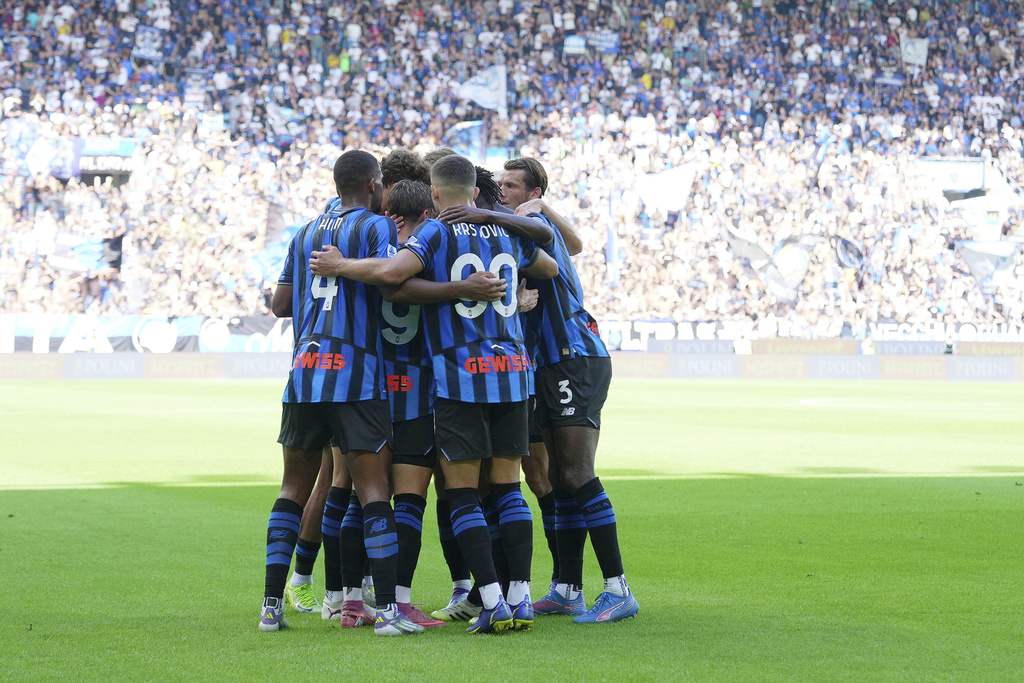 Atalanta's players celebrate after Giorgio Scalvini scored his side's opening goal during the Serie A soccer match between Atalanta and Lecce at the New Balance Stadium in Bergamo, Italy, Sunday, Sept. 14, 2025. (Spada/LaPresse via AP)
