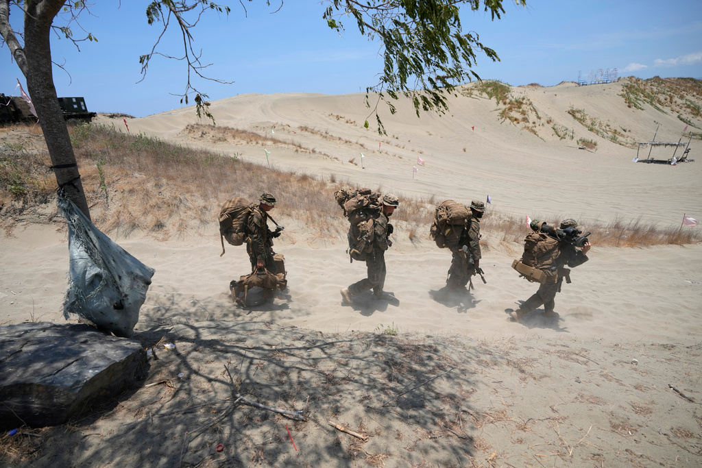 FILE -U.S. troopers in battle gear walk during a joint military exercise on May 8, 2024, in Laoag, Ilocos Norte, northern Philippines. (AP Photo/Aaron Favila, File)