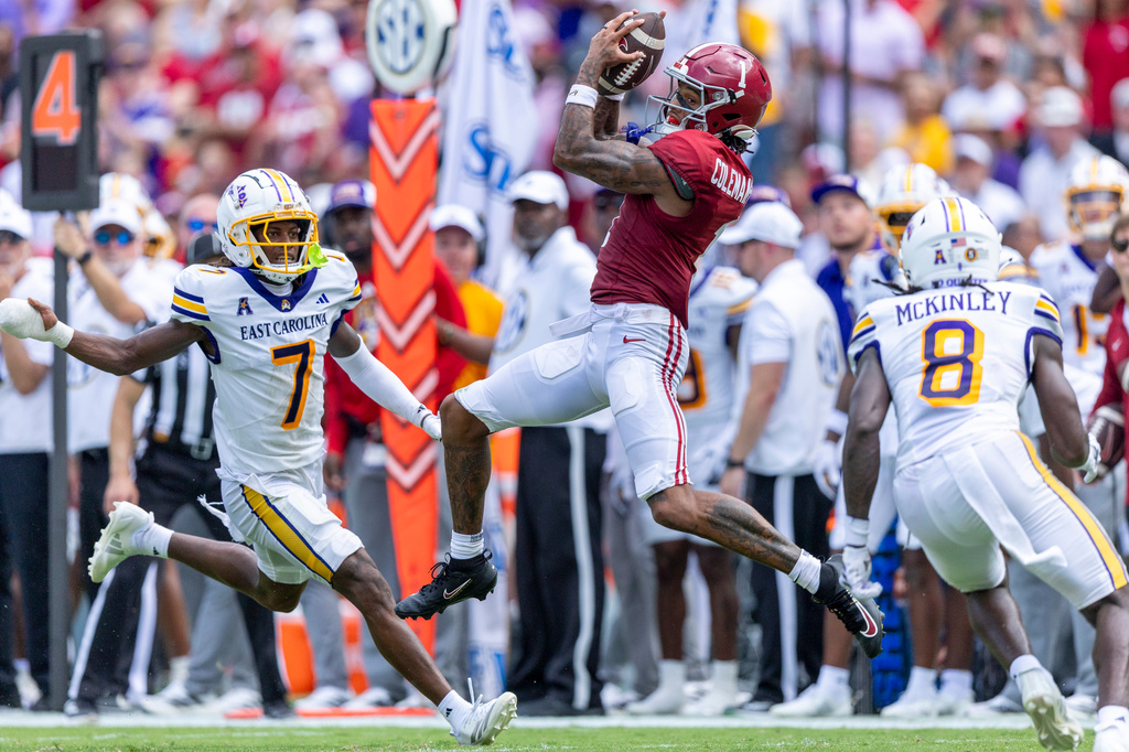 Alabama wide receiver Ryan Coleman-Williams (1) leaps for a catch between of East Carolina defensive backs Ashton Levells-Mitchell (7) and Kamaurri McKinley (8) during the first half of an NCAA college football game Saturday, Sept. 5, 2026, in Tuscaloosa, Ala. (AP Photo/Vasha Hunt)