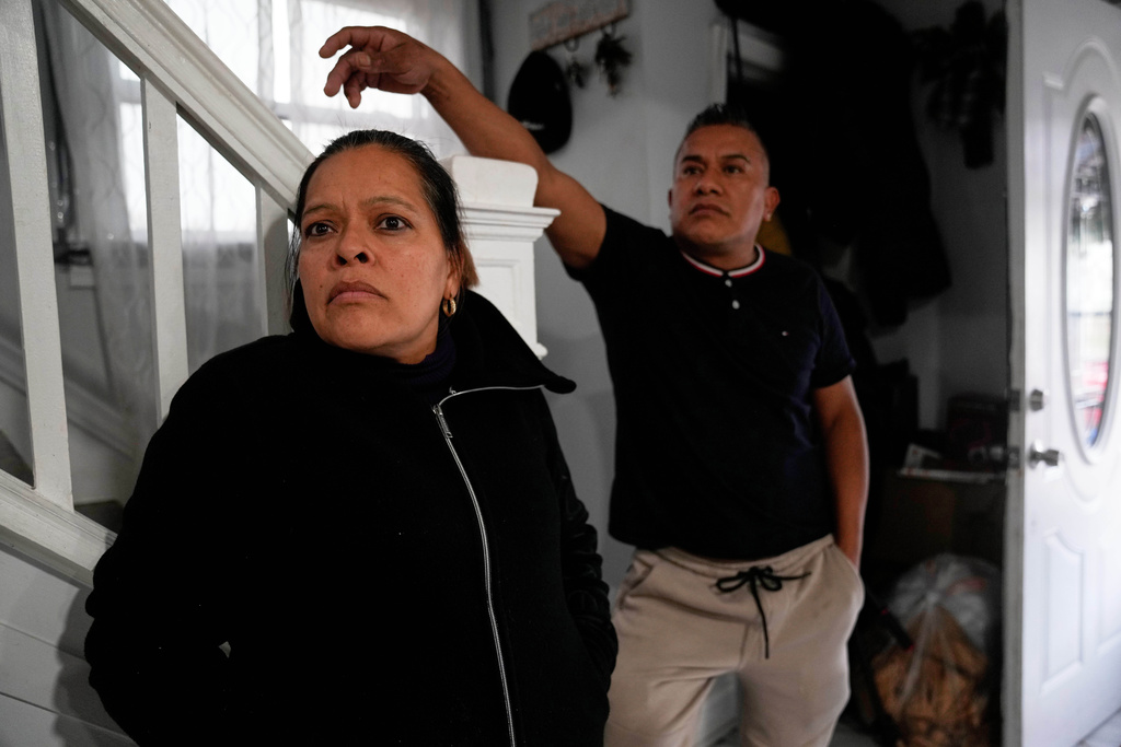 Ofelia Herrera, left, and her husband, Rafael Hernandez, both originally from Mexico, stand inside their home, Nov. 6, 2025, in Chicago. (AP Photo/Erin Hooley)