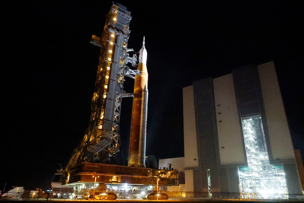 The NASA Artemis II rocket with the Orion spacecraft aboard leaves the Vehicle Assembly Building moving slowly to pad 39B at the Kennedy Space Center in Cape Canaveral, Fla., Friday, March 20, 2026. (AP Photo/Terry Renna)