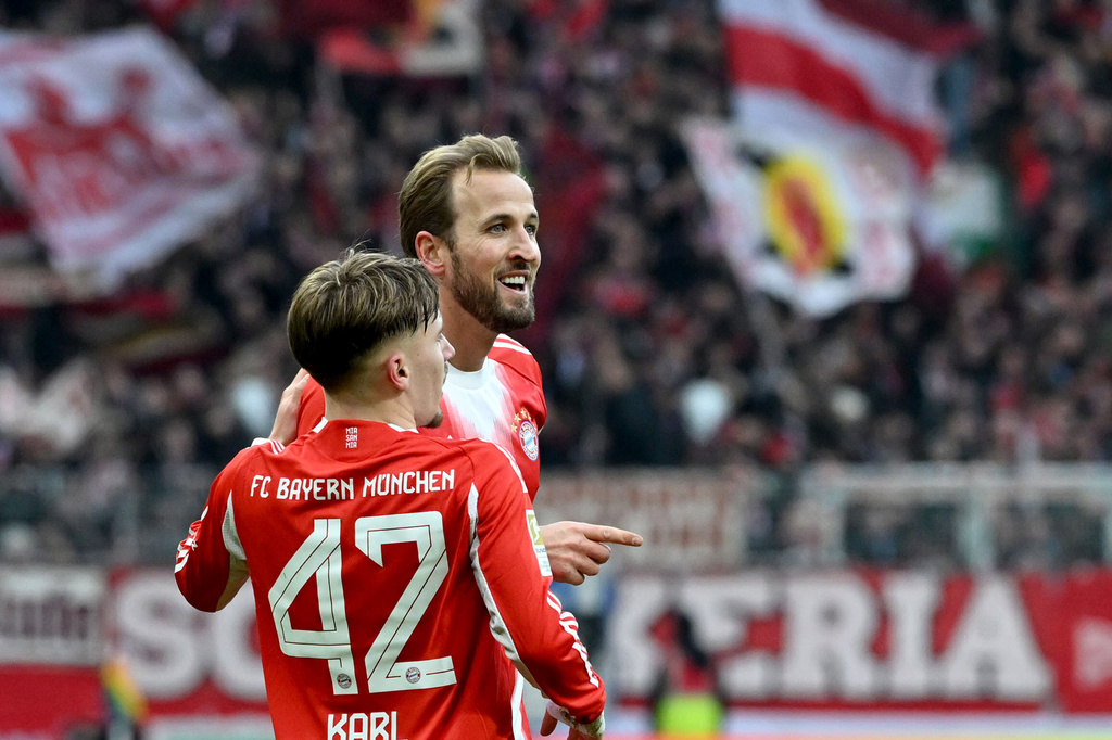 Bayern's Harry Kane, right, celebrates with Lennard Karl after scoring his side's second goal during the German Bundesliga soccer match between Werder Bremen and Bayern Munich, in Bremen, Germany, Saturday, Dec. 14, 2026. (Carmen Jaspersen/dpa via AP)