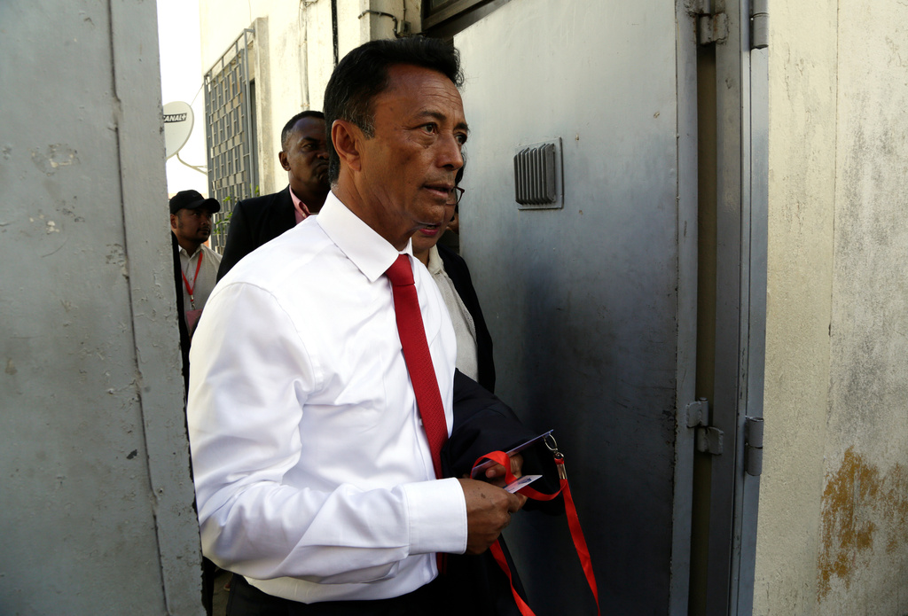 FILE - Presidential candidate Marc Ravalomanana leaves the polling station after casting his vote in the runoff presidential election in Antananarivo, Madagascar, Dec. 19, 2018. (AP Photo/Themba Hadebe, File)