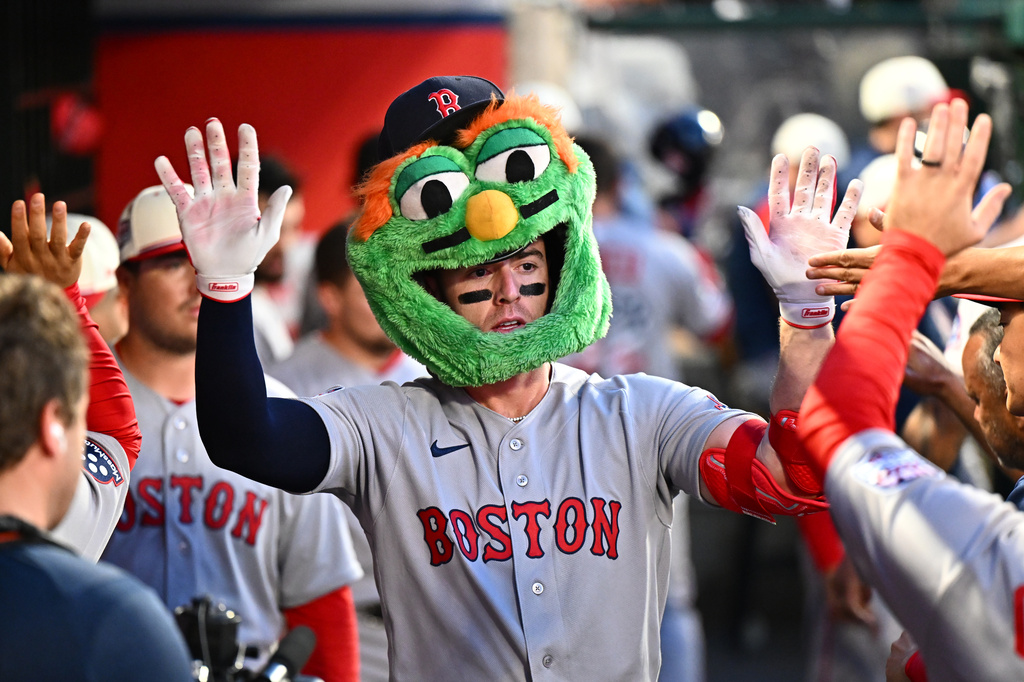 Boston Red Sox's Romy Gonzalez, center, is greeted by teammates after hitting a two-run home run during the fifth inning of a baseball game against the Los Angeles Angels, Saturday, July 4, 2026, in Anaheim, Calif. (AP Photo/William Liang)