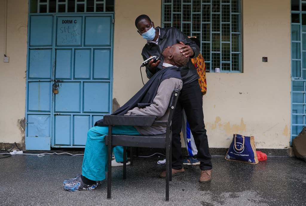A barber shave a patients hair during a grooming session at the largest mental health referral hospital, Mathari in Nairobi, Kenya, Tuesday, June 30, 2026. (AP Photo/Andrew Kasuku)