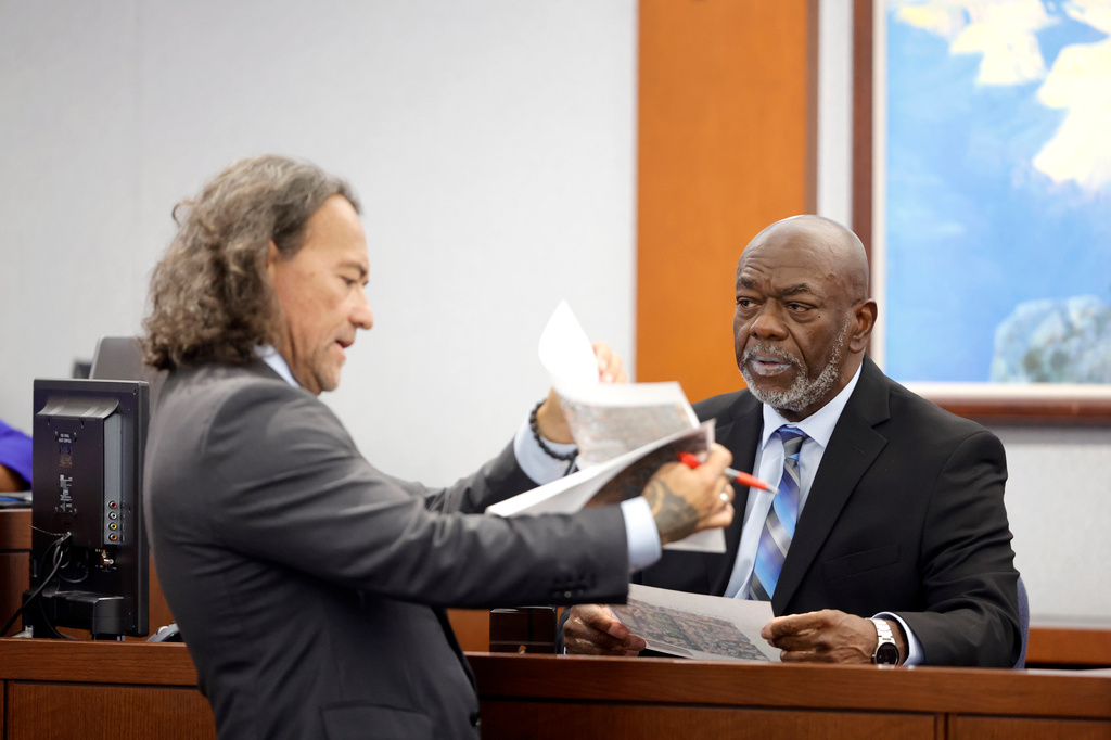 Defense attorney Michael Sanft shows exhibits to former Las Vegas Metro Police Officer Charlie Mangrum during the Duane Davis trial, related to the 1996 killing of rapper Tupac Shakur, in Clark County District Court at the Regional Justice Center in Las Vegas on Thursday, Aug. 27, 2026. (Steve Marcus/Las Vegas Sun via AP, Pool)