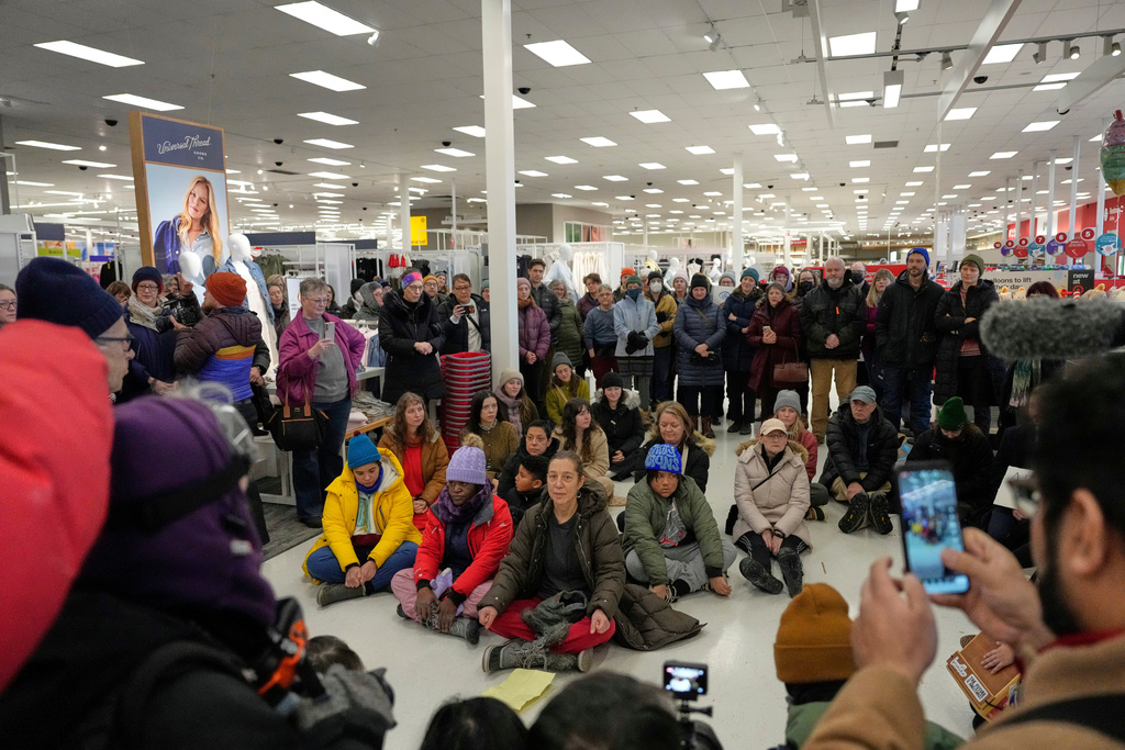 Community members and neighbors of people detained by ICE gather in protest at a Target store, Monday, Jan. 19, 2026, in St. Paul, Minn. (AP Photo/Yuki Iwamura)