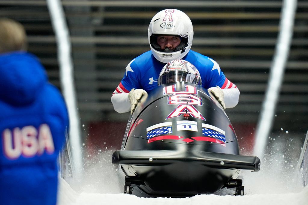 United States' Kristopher Horn, Caleb Furnell, Hunter Powell and Carsten Vissering arrive at the finish during a four man bobsled run at the 2026 Winter Olympics, in Cortina d'Ampezzo, Italy, Sunday, Feb. 22, 2026. (AP Photo/Aijaz Rahi)