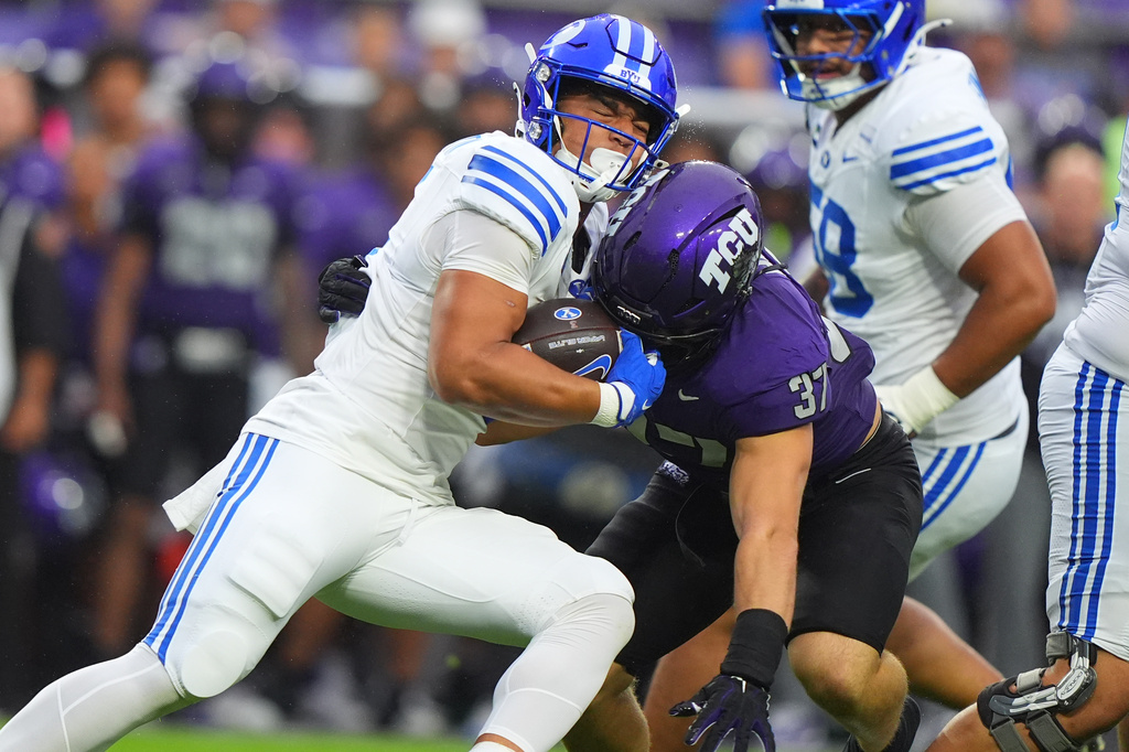 BYU running back Lj Martin, left, runs into TCU linebacker Hudson Hooper (37) during the first half of an NCAA college football game Saturday, Oct. 3, 2026, in Fort Worth, Texas. (AP Photo/LM Otero)