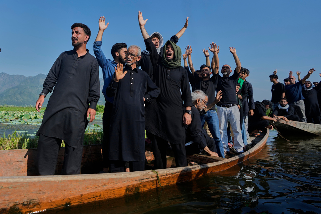 Kashmiri Shiite Muslims shout slogans against Israel and the U.S. as they participate in a Muharram procession aboard wooden boats in the interior of Dal Lake on the outskirts of Srinagar, Indian controlled Kashmir, Thursday, June 25, 2026. (AP Photo/Mukhtar Khan)