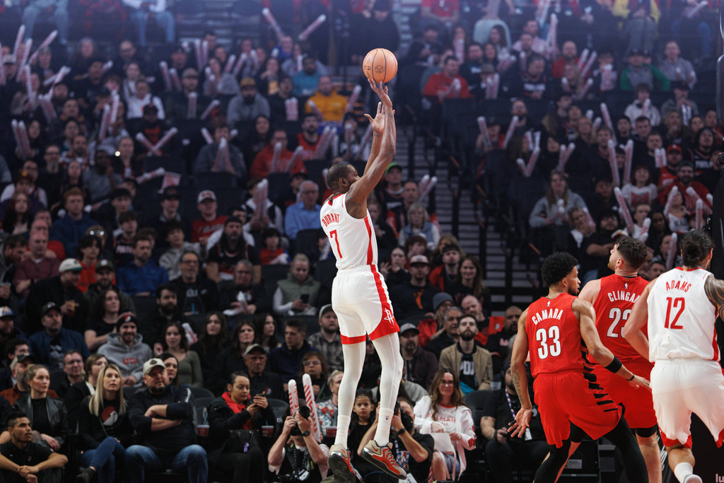 Houston Rockets forward Kevin Durant, center, shoots against the Portland Trail Blazers during the first half of an NBA basketball game Friday, Jan. 9, 2026, in Portland, Ore. (AP Photo/Howard Lao)