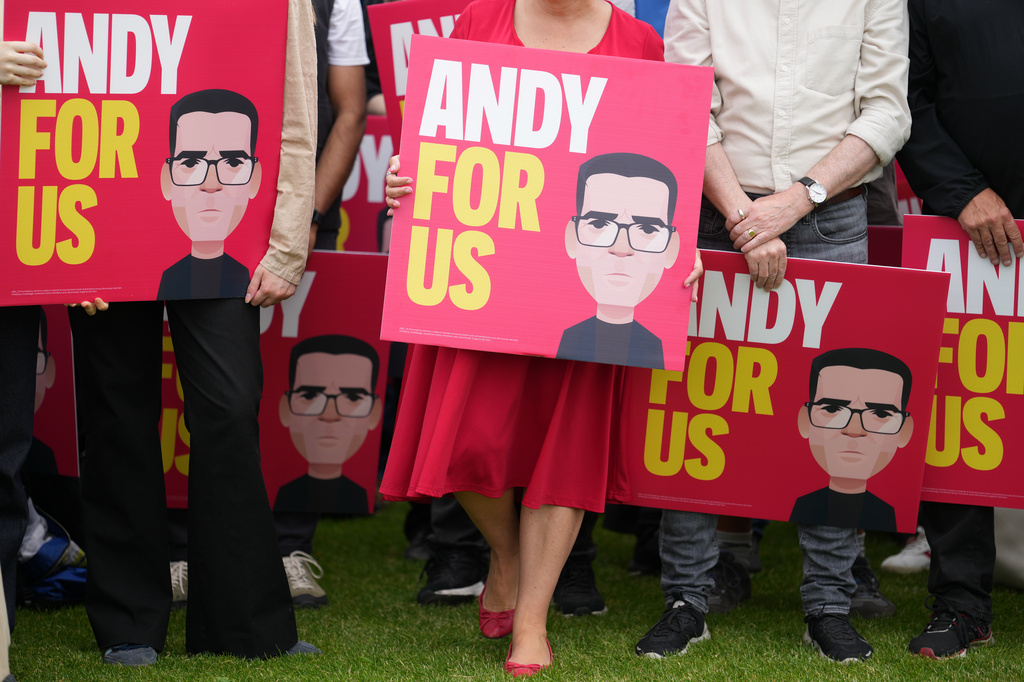 Supporters of Britain's Labour party MP Andy Burnham show placards before his speech after the Makerfield by-election in Wigan, England, Friday, June 19, 2026.(AP Photo/Jon Super)