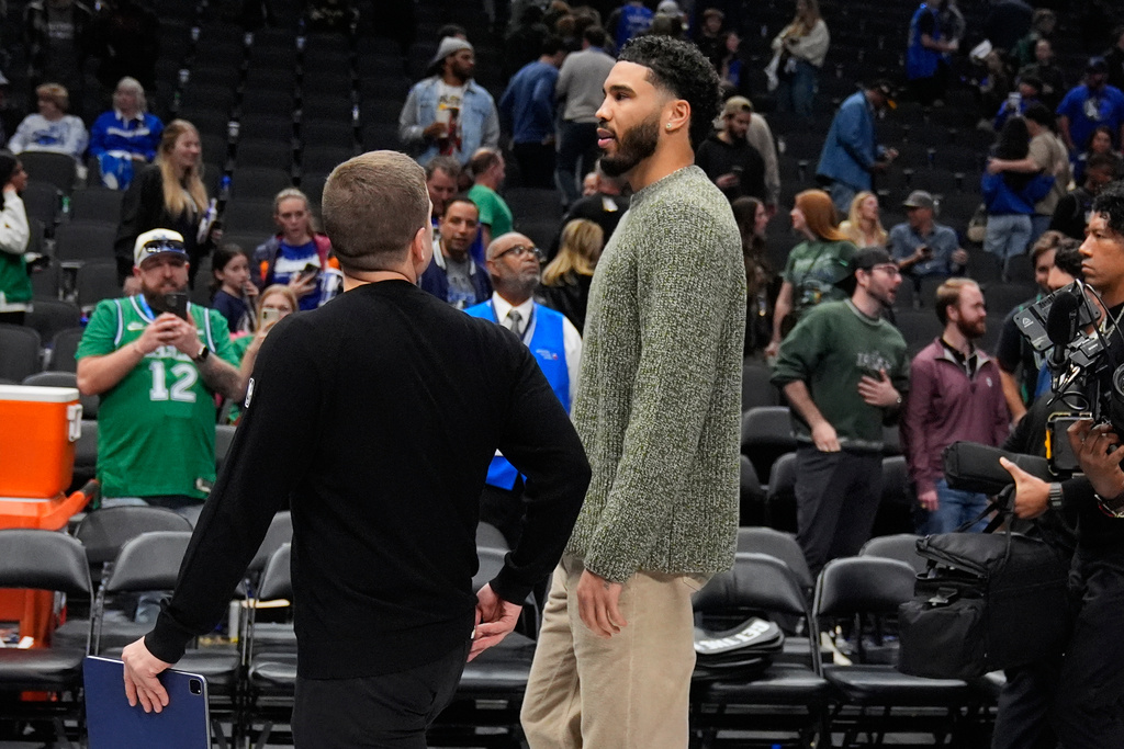 Boston Celtics forward Jayson Tatum, right, walks off the court after an NBA basketball game against the Dallas Mavericks Tuesday, Feb. 3, 2026, in Dallas. (AP Photo/Tony Gutierrez)