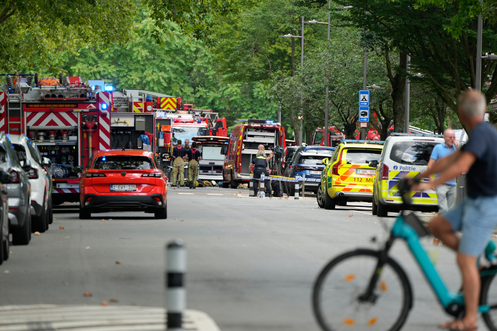 Emergency workers on the street after a fire broke out in an apartment block in Linkeroever, Belgium, Wednesday, July 1, 2026. (AP Photo/Virginia Mayo)