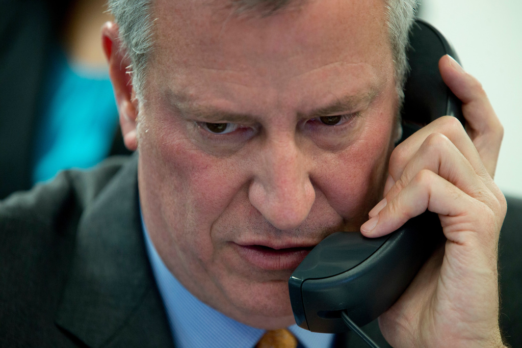 FILE - Then-New York City Mayor Bill de Blasio takes a phone call during the 14th Annual CUNY/Daily News Citizenship NOW! event, April 28, 2016, in New York. (AP Photo/Mary Altaffer, file)