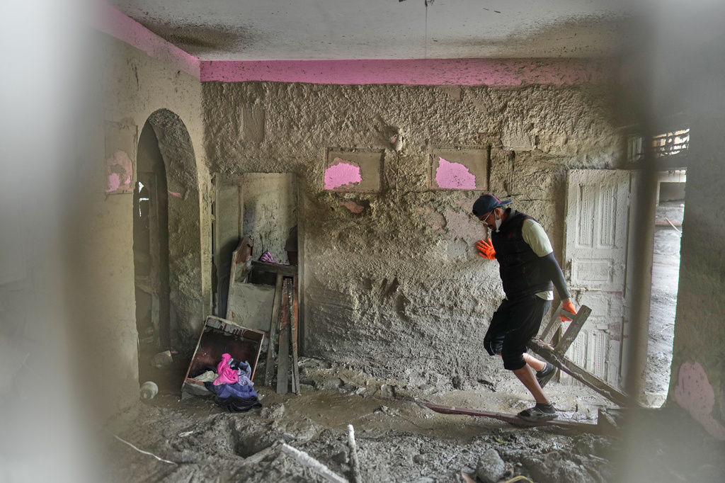 A resident salvages usable material from his house damaged by flash flooding at 1 Number Pul, in Nepal's Nuwakot district, Tuesday, Sept. 1, 2026. (AP Photo/Rajesh Kumar Singh)
