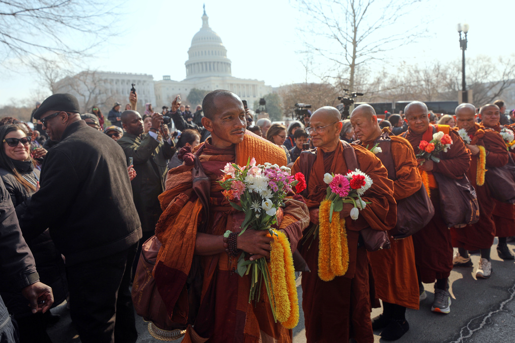 Buddhist monks walk near the U.S. Capitol, on Capitol Hill, during the Walk For Peace, Wednesday, Feb. 11, 2026, in Washington. (AP Photo/Rahmat Gul)