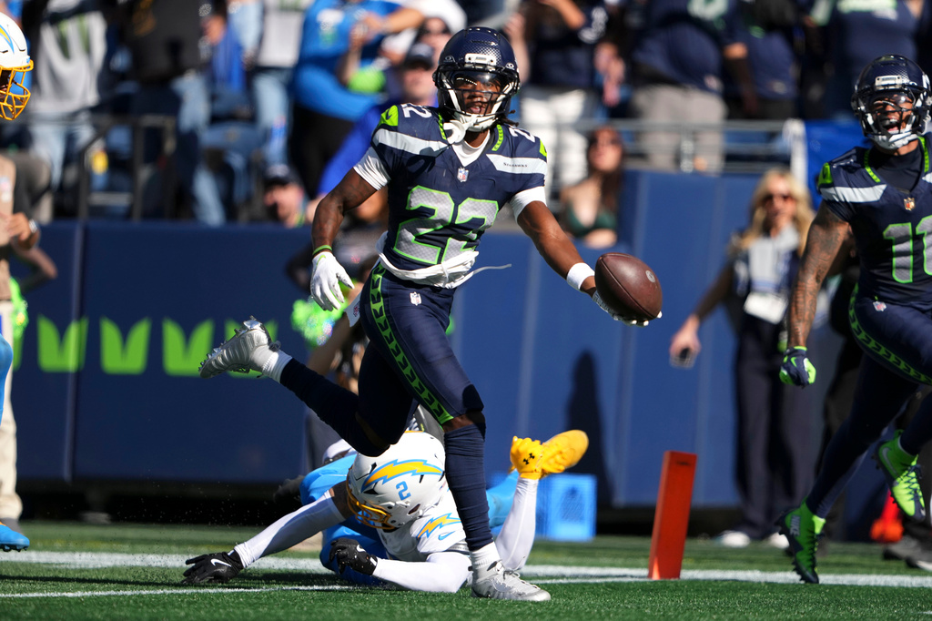 Seattle Seahawks wide receiver Rashid Shaheed (22) scores a touchdown over Los Angeles Chargers cornerback Elijah Molden (2) during the first half of an NFL football game, Sunday, Oct. 4, 2026, in Seattle. (AP Photo/Lindsey Wasson)