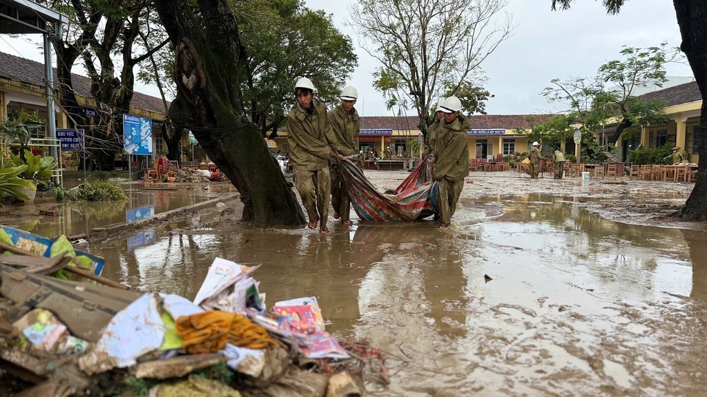 People clean up after flood recedes in Dak Lak, Vietnam Monday, Nov. 24, 2025. (Nguyen Dung/VNA via AP)
