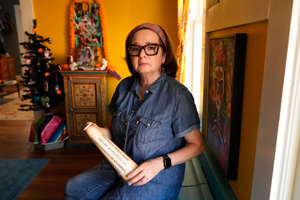 Gigi Cervantes, who resigned from her position as a theater teacher at a Fort Worth school rather than teach in a classroom where the Ten Commandments are hung, poses for a photo at her home, Wednesday, Nov. 5, 2025, in Fort Worth, Texas. (AP Photo/Tony Gutierrez)