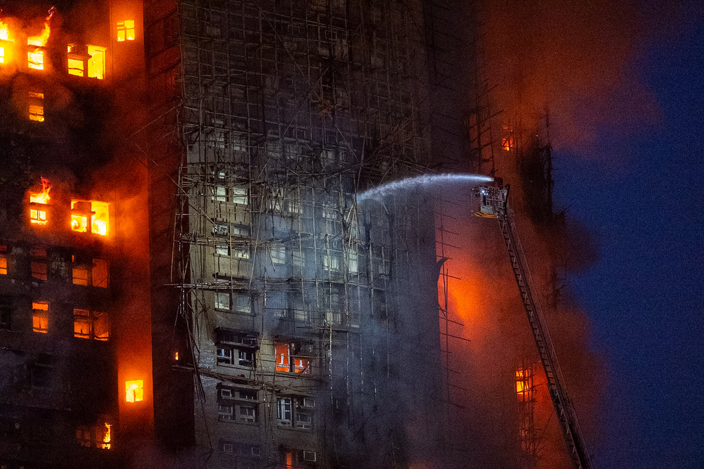 Firefighters work to extinguish a fire which broke out at Wang Fuk Court, a residential estate in the Tai Po district of Hong Kong's New Territories, Wednesday, Nov. 26 2025. (AP Photo/Chan Long Hei)
