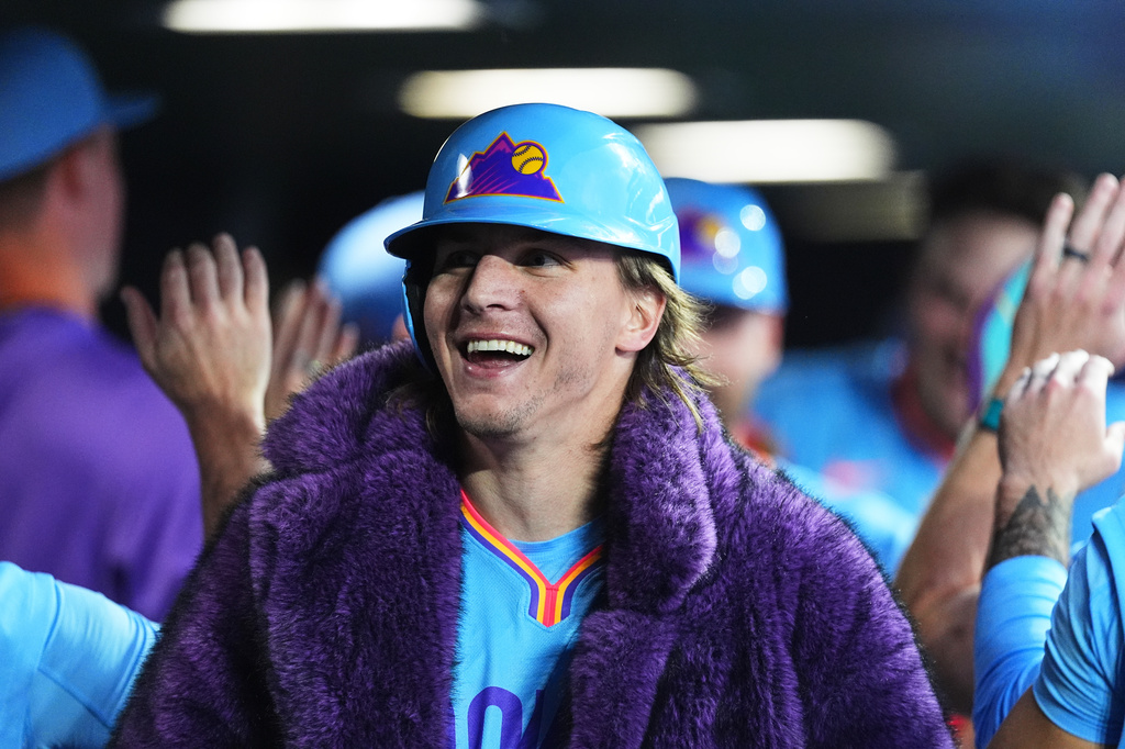 Colorado Rockies' Jake McCarthy is congratulated as he returns to the dugout after hitting a grand slam off San Francisco Giants relief pitcher Matt Gage in the fifth inning of a baseball game Friday, July 3, 2026, in Denver. (AP Photo/David Zalubowski)
