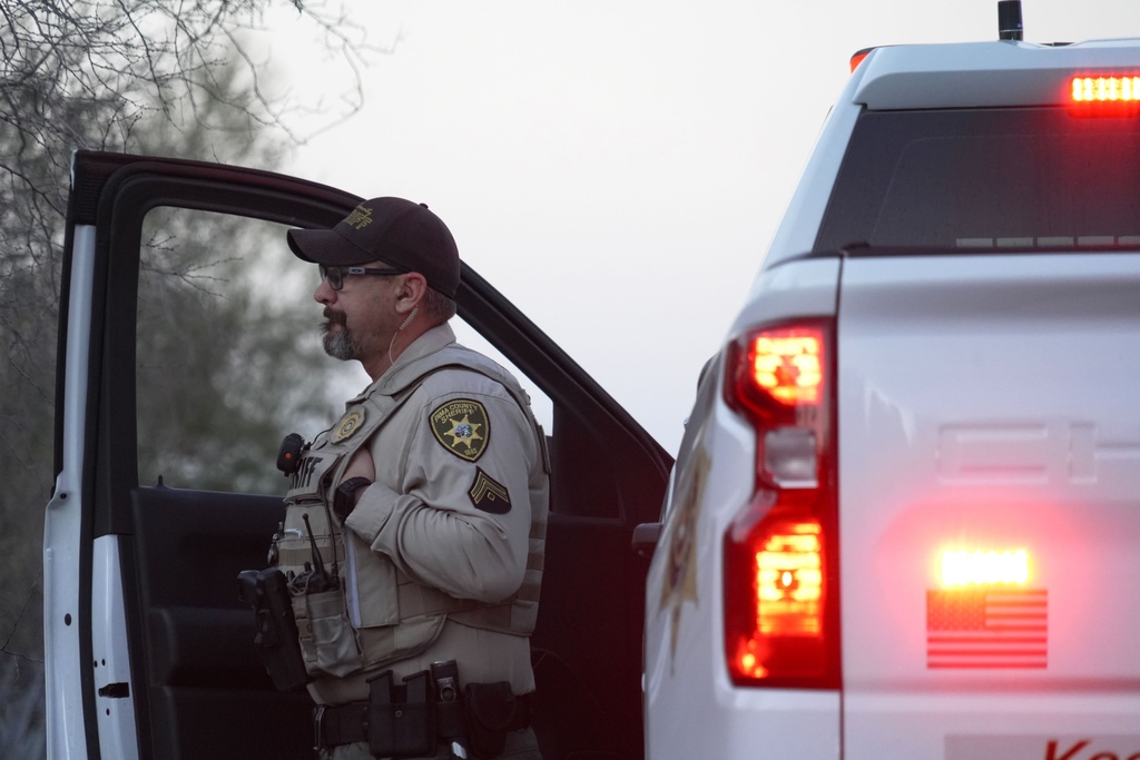 A member of the Pima County sheriffs office stands by his truck looking at Nancy Guthrie‘s house, Monday, Feb. 9, 2026 in Tucson, Ariz. (AP Photo/Ty ONeil)
