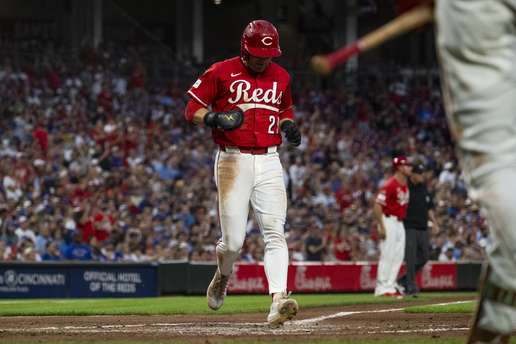 Cincinnati Reds' TJ Friedl scores after Will Benson hit a single in the third inning of a baseball game against the Chicago Cubs, Saturday, Sept. 20, 2025, in Cincinnati. (AP Photo/Michael Swensen)