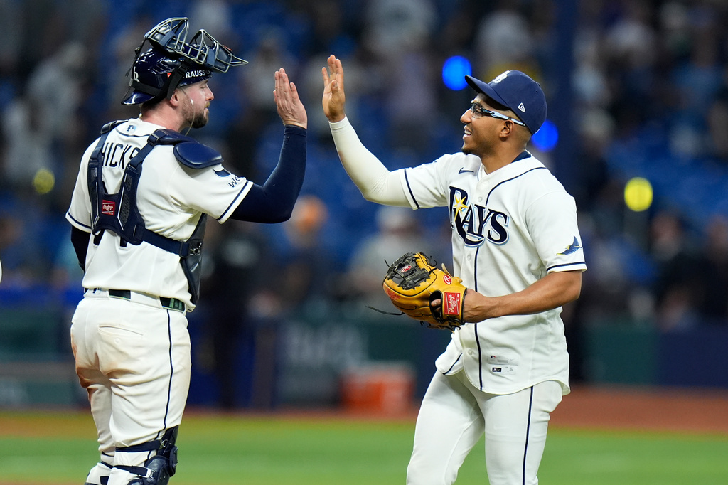 Tampa Bay Rays' Richie Palacios, right, and Liam Hicks celebrate a victory over the New York Yankees in Game 2 of an American League Division Series baseball game Monday, Oct. 5, 2026, in St. Petersburg, Fla. (AP Photo/Chris O'Meara)