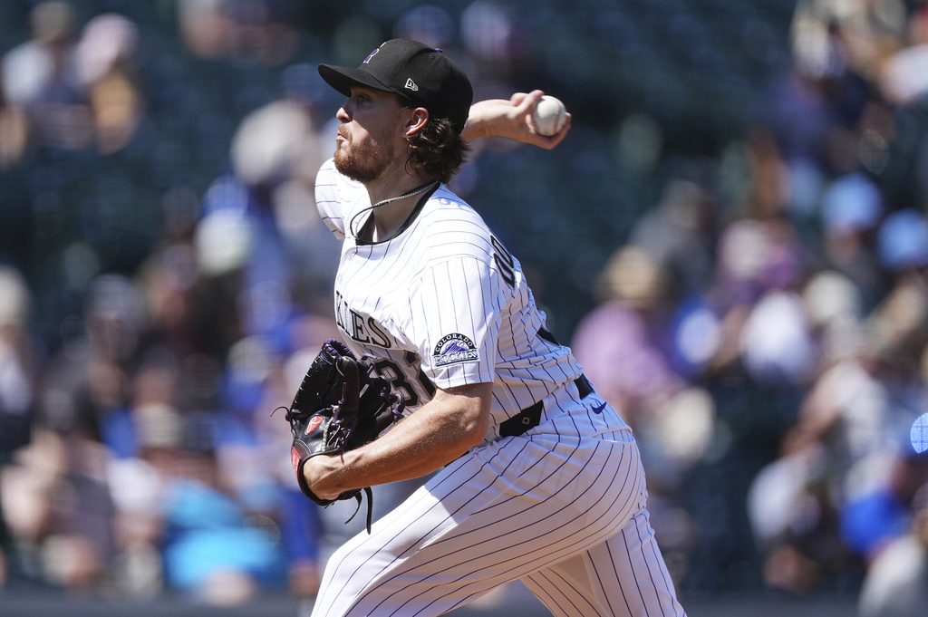 Colorado Rockies starting pitcher Chase Dollander works against the Los Angeles Dodgers in the first inning of a baseball game Thursday, Aug. 21, 2025, in Denver. (AP Photo/David Zalubowski)