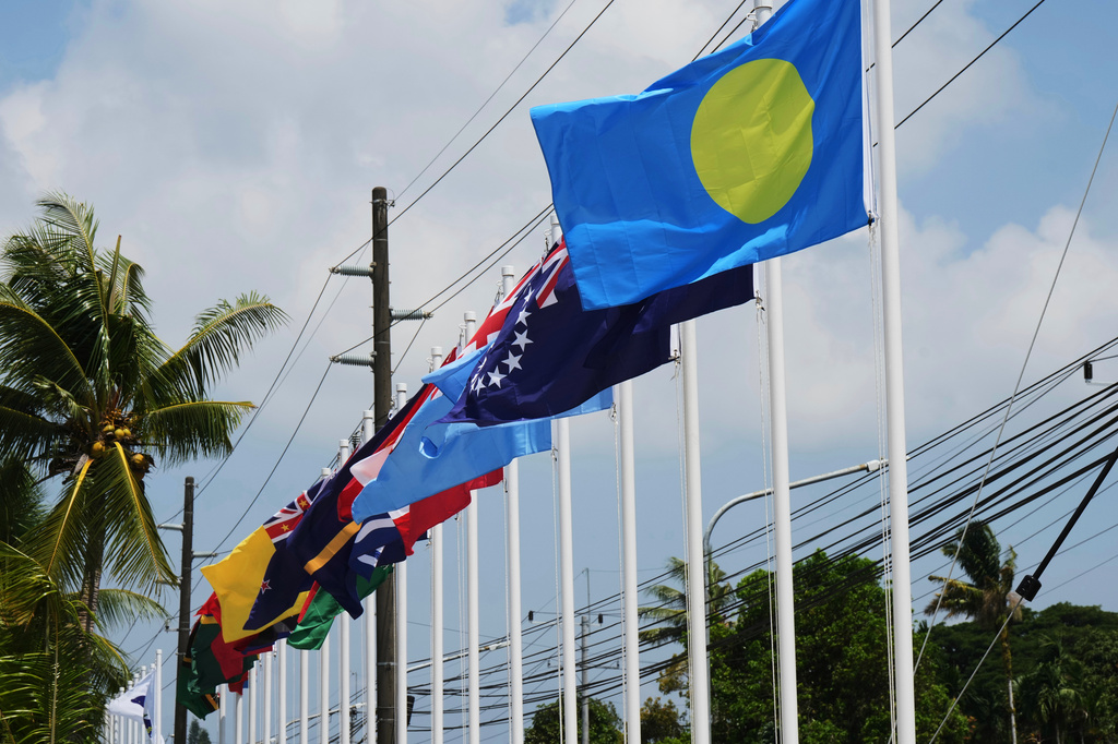 Flags of member states fly outside the summit venue for the Pacific Islands Forum Leaders Meeting in Koror, Palau, Sunday, Aug. 30, 2026. (AP Photo/Charlotte Graham-McLay)