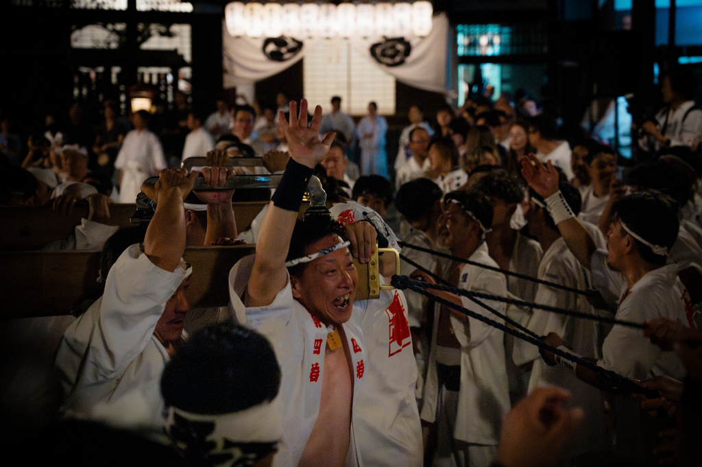 Festival participants carry Yasaka Shrine's Eastern Mikoshi back into the shrine's main hall following the "Mikoshi Arai" purification ritual ahead of the Gion Matsuri festival in Kyoto, western Japan, Friday, July 10, 2026. (AP Photo/Fred Mery)