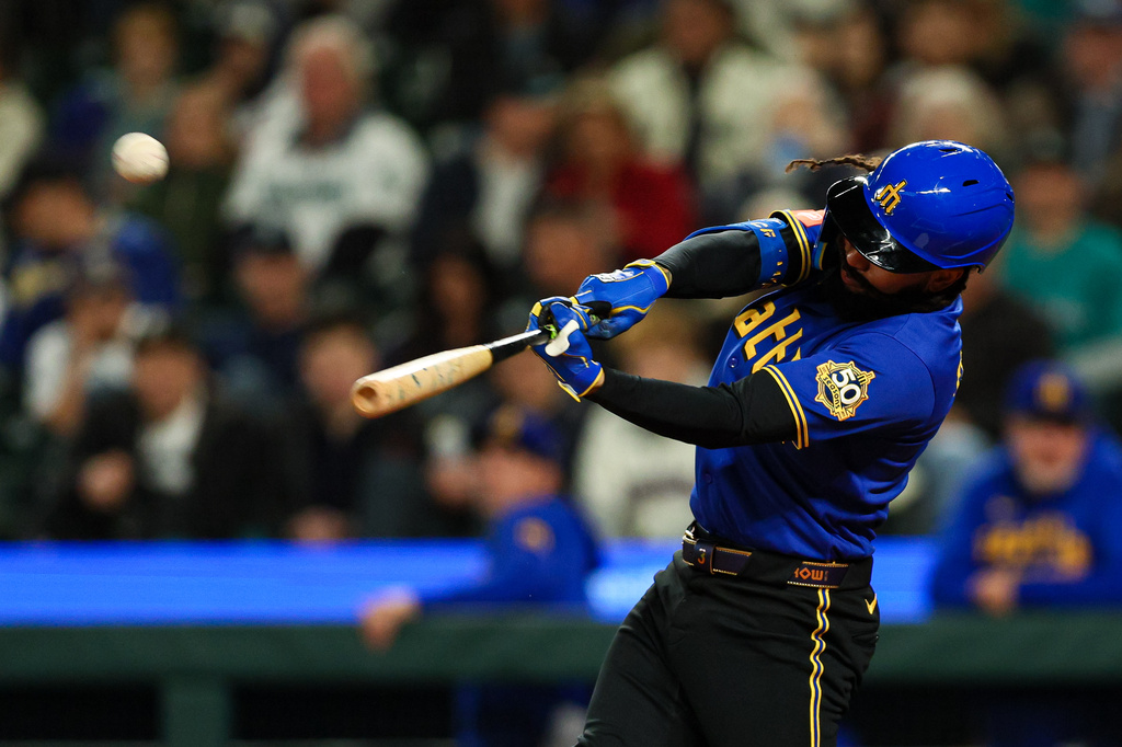 Seattle Mariners' J.P. Crawford hits a one-run home run against the Arizona Diamondbacks during the first inning of a baseball game Friday, May 29, 2026, in Seattle. (AP Photo/Caean Couto)