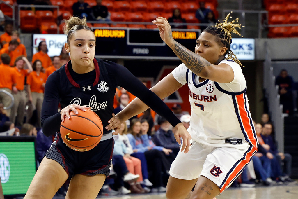 South Carolina guard Tessa Johnson, left, drives to the basket around Auburn guard A'riel Jackson, right, during the first period of an NCAA college basketball game Thursday, Jan. 29, 2026, in Auburn, Ala. (AP Photo/Butch Dill)