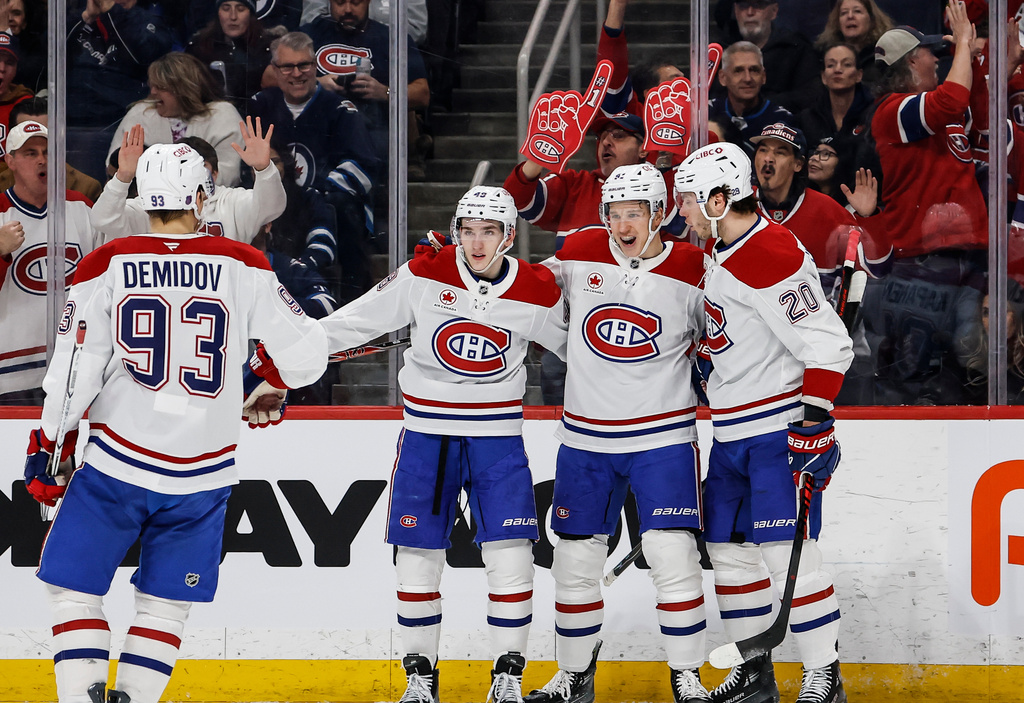 Montreal Canadiens' Oliver Kapanen, second right, celebrates his goal against the Winnipeg Jets with Ivan Demidov, left to right, Lane Hutson and Juraj Slafkovsky during the first period of an NHL hockey game in Winnipeg, Manitoba, Wednesday, Feb. 4, 2026. (John Woods/The Canadian Press via AP)